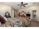 Spacious main bedroom with a decorative bedspread, carpet flooring, and a private door to the outside at 5735 S Cloverdale Ln, Gilbert, AZ 85298