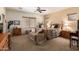 Comfortable main bedroom with a ceiling fan, neutral colors, and carpet flooring at 5735 S Cloverdale Ln, Gilbert, AZ 85298