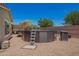 Backyard pool with ladder, umbrella, and pool equipment on a sunny day, great for outdoor relaxation at 5735 S Cloverdale Ln, Gilbert, AZ 85298