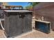 Exterior view of a closed pool storage cabinet near the pool, enhancing backyard organization and aesthetics at 5735 S Cloverdale Ln, Gilbert, AZ 85298