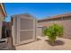 Backyard with storage shed and desert landscaping offering functional outdoor space at 5735 S Cloverdale Ln, Gilbert, AZ 85298