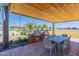 Outdoor grilling station features stainless steel grills, countertop space, dining table, and a wooden pergola at 6122 S Antonio --, Mesa, AZ 85212