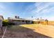 Backyard features a spacious lawn area and mature trees providing shade at 635 W Flower Ave, Mesa, AZ 85210