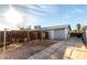 Backyard features a fenced lot, patio area and mature trees for shade at 635 W Flower Ave, Mesa, AZ 85210