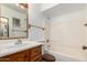 Functional bathroom featuring classic vanity and tub-shower combination at 635 W Flower Ave, Mesa, AZ 85210