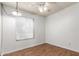 Cozy room with wood floor, natural light from the window and ceiling fan at 635 W Flower Ave, Mesa, AZ 85210