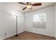 Bedroom with wood-look floors is bright with a standard lamp and window at 635 W Flower Ave, Mesa, AZ 85210