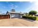 Charming single-story home with a large driveway and well-maintained landscaping at 635 W Flower Ave, Mesa, AZ 85210