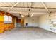 Spacious garage featuring ample storage, a work area, and a convenient entryway to the home at 635 W Flower Ave, Mesa, AZ 85210
