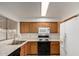 Practical kitchen features standard appliances, tile floors, and efficient design at 635 W Flower Ave, Mesa, AZ 85210