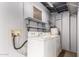 Cozy laundry room featuring a washer and dryer, shelving, and connections at 635 W Flower Ave, Mesa, AZ 85210