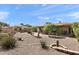 Backyard featuring decorative desert landscaping and mature trees at 6448 E Des Moines St, Mesa, AZ 85205