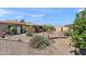 Backyard with desert landscaping, patio, storage shed and block wall at 6448 E Des Moines St, Mesa, AZ 85205