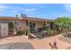 Well-maintained backyard with brick patio, desert landscaping, and covered area, perfect for outdoor enjoyment at 6448 E Des Moines St, Mesa, AZ 85205