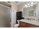 Bathroom featuring a granite countertop, cabinet for storage, and a shower at 6448 E Des Moines St, Mesa, AZ 85205