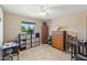 Well-lit bedroom with neutral walls, tile floor, a ceiling fan, and multiple storage options at 6448 E Des Moines St, Mesa, AZ 85205