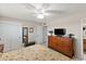 Bedroom with ceiling fan, dresser with tv, and closet at 6448 E Des Moines St, Mesa, AZ 85205