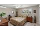 Comfortable bedroom with plantation shutters, ceiling fan, and neutral tones at 6448 E Des Moines St, Mesa, AZ 85205