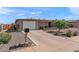 Single-story home with a well-maintained yard, long driveway, and attached two car garage at 6448 E Des Moines St, Mesa, AZ 85205