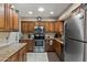 Updated kitchen with stainless steel appliances, granite countertops, and abundant cabinet space at 6448 E Des Moines St, Mesa, AZ 85205