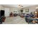 Inviting living room with tile flooring, bright windows, ceiling fan, and comfortable seating arrangement at 6448 E Des Moines St, Mesa, AZ 85205