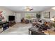 Relaxing living room featuring tile floors, bright windows, a ceiling fan, and comfortable seating at 6448 E Des Moines St, Mesa, AZ 85205