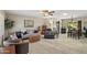 Comfortable living room featuring tiled floors, a ceiling fan, and an open layout to the dining area at 6448 E Des Moines St, Mesa, AZ 85205