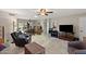 Open-concept living room with tiled floors, an open layout, and a ceiling fan at 6448 E Des Moines St, Mesa, AZ 85205