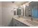 Bathroom featuring double sinks, modern lighting, and a clean aesthetic at 6944 E Gary Cir, Mesa, AZ 85207