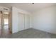 Bedroom with tiled floor and a closet with sliding doors at 6944 E Gary Cir, Mesa, AZ 85207
