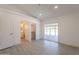 This bedroom includes a walk-in closet, ensuite bathroom, wood-look tile flooring and a sliding glass door at 6944 E Gary Cir, Mesa, AZ 85207