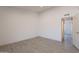 Neutral bedroom with tile floors, natural light, and an open doorway leading to an attached room at 6944 E Gary Cir, Mesa, AZ 85207