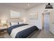 Comfortable bedroom with neutral walls, features modern lamps, stylish decorations and a cozy bed setting at 6944 E Gary Cir, Mesa, AZ 85207
