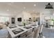 Bright dining area showcases a spacious marble table, stylish chairs and an open-concept view into the modern kitchen at 6944 E Gary Cir, Mesa, AZ 85207