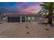Charming single-story home featuring a two-car garage and desert-style landscaping for easy maintenance at 6944 E Gary Cir, Mesa, AZ 85207