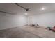 Attached garage with sealed concrete floor, white-painted brick wall and automatic overhead door at 6944 E Gary Cir, Mesa, AZ 85207