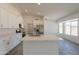 Bright kitchen featuring modern appliances, light countertops, an island with bar seating, and plenty of cabinet space at 6944 E Gary Cir, Mesa, AZ 85207