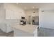 Bright kitchen featuring modern appliances, light countertops, an island with bar seating, and plenty of cabinet space at 6944 E Gary Cir, Mesa, AZ 85207