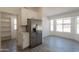 Bright kitchen features stainless steel refrigerator, an island with bar seating, and a large pantry at 6944 E Gary Cir, Mesa, AZ 85207