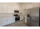 Modern kitchen featuring stainless steel appliances, white cabinets, and a pantry at 6944 E Gary Cir, Mesa, AZ 85207