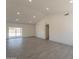 The spacious living area is bright, with a sliding glass door, recessed lighting and modern wood-style tile floors at 6944 E Gary Cir, Mesa, AZ 85207