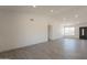 This living room offers an open floor plan with wood-style tile flooring, bright lighting, and modern design at 6944 E Gary Cir, Mesa, AZ 85207