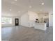 Open floor plan living room is bright, offering lots of space, wood-style tile floors and views into the kitchen at 6944 E Gary Cir, Mesa, AZ 85207