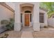 Charming front door surrounded by desert landscaping and stucco pillars, creating a welcoming entrance at 8158 E Rita Dr, Scottsdale, AZ 85255