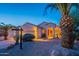 Inviting single-story home with desert landscaping and a lit front entrance, highlighted at twilight at 8158 E Rita Dr, Scottsdale, AZ 85255