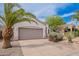 Single-story home features stucco, desert landscaping, and a spacious garage, set against a bright blue sky at 8158 E Rita Dr, Scottsdale, AZ 85255