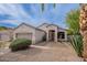 Front of a single-story home with desert landscaping and a spacious garage is brightened under the afternoon sky at 8158 E Rita Dr, Scottsdale, AZ 85255