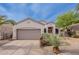 Single-story home with desert landscaping and a spacious garage is displayed under a sunny, blue sky at 8158 E Rita Dr, Scottsdale, AZ 85255