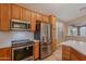 Close up of kitchen featuring stainless steel appliances, a microwave, and light wood cabinets at 8158 E Rita Dr, Scottsdale, AZ 85255