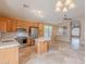 Well-lit kitchen with stainless steel appliances, travertine floors, and a view of the spacious living area at 8158 E Rita Dr, Scottsdale, AZ 85255